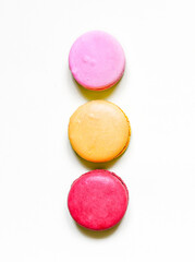 Colorful macarons on white background.