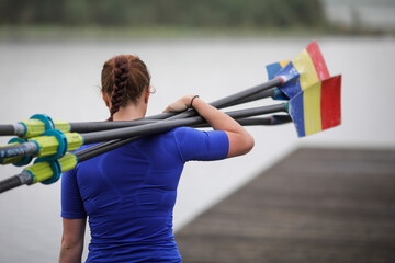 Romanian professional women rowers from the Olympic Team train in a sports base. - obrazy, fototapety, plakaty
