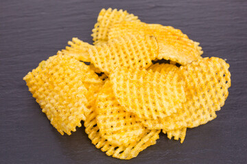 heap of salted lattice cut potato chips
