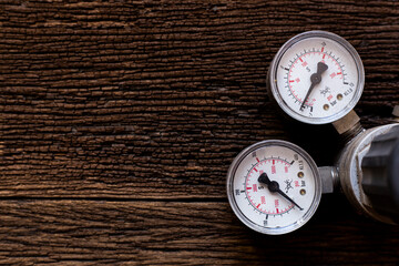 old pressure gauge on wood table background, engineering equipment