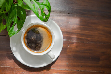 Black coffee on the wooden table, soft focus image
