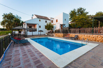 Fototapeta na wymiar Exterior terrace of a rural rental house with pool in Spain.