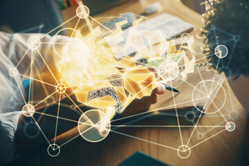 Multi exposure of writing hand on background with brain hologram. Concept of self learning.