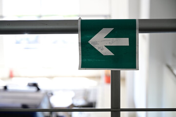 Photo of a sign on a wall in the interior inside the building.