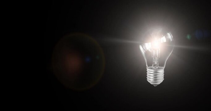 Light bulb with electric power abstract creative idea think innovation technology inspiration with flickering light lens flare on isolated black backgrounds