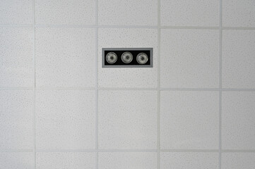 Photo of the ceiling in a building with lighting and alarm elements
