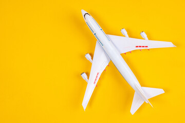 Airplane model. Large passenger plane top view. Two-story liner on a yellow background. Concept -...