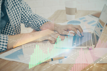 Multi exposure of stock market chart with man working on computer on background. Concept of financial analysis.