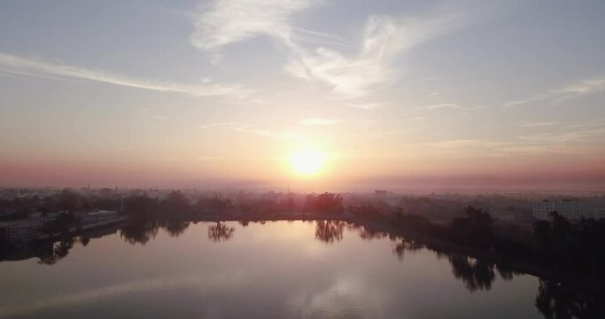Beautiful Sunset Reflection On River In Chhattisgarh, India - Drone Shot