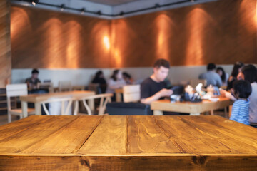 Empty wooden table space platform and blurred restaurant or coffee shop background for product display montage