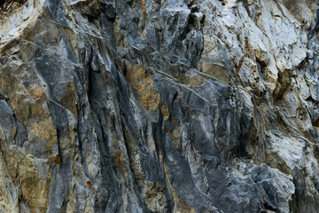 nature, adventure and tourism concept - stone surface of mountains close-up