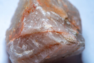 The texture of natural quartz with chips and interspersed in different shades of red with a strong increase and soft focus.