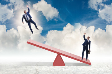 Competition concept with businessman and seesaw