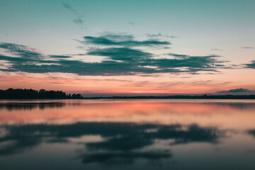Fototapeta na wymiar beautiful sunset over the lake. bloody sunset over a calm lake