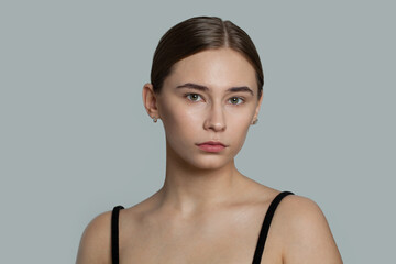 Naklejka premium Beautiful female face. Healthy model with clear skin. Skincare and facial treatment concept