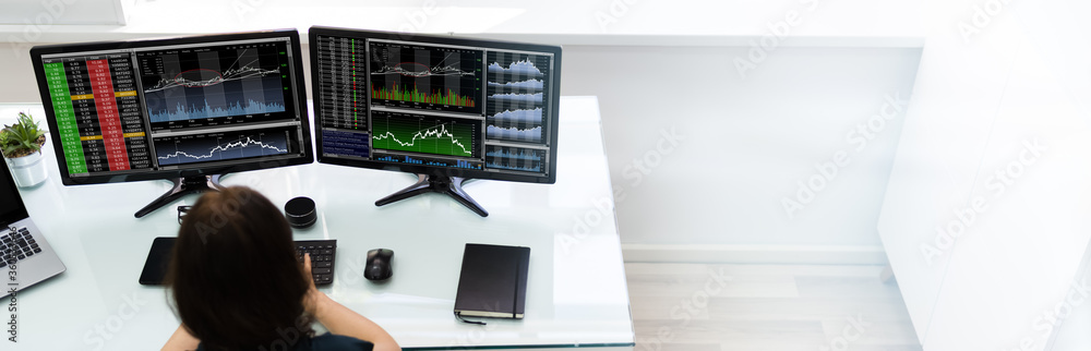 Poster stock analyst working on computer
