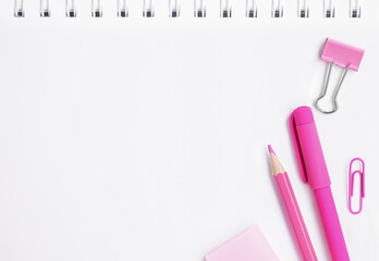 Pink office supplies on white background with copy space. Pink pen, pink pencil. 