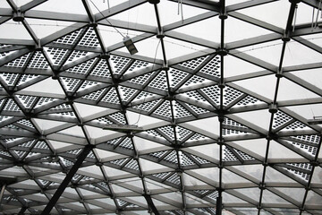 Close-up gray abstract image of a metal triangular lattice. Abstraction, background, texture, substrate.