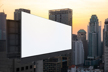Obraz premium Blank white road billboard with Bangkok cityscape background at sunset. Street advertising poster, mock up, 3D rendering. Side view. The concept of marketing communication to promote or sell idea.