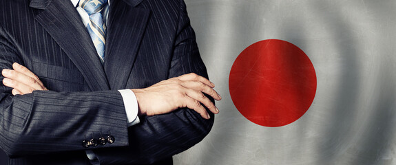 Male hands against japanese flag background, business, politics and education in Japan concept