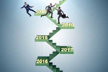 Businessman climbing stairs on yearly basis