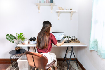 young woman working in the living room at home