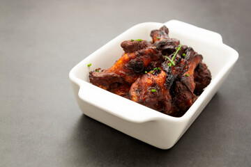 Barbecue chicken legs, drumsticks on plate, isolated, copy space.