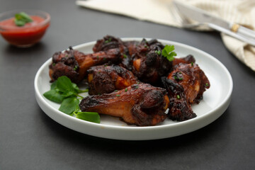 Glazed bbq chicken legs, drumsticks on plate, isolated