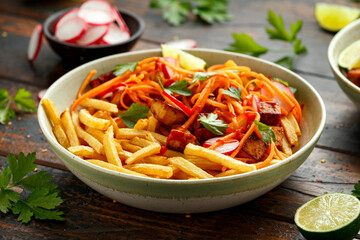 Loaded French Vegan Fries with tofu, pickled vegetables radish, carrot and spicy hot sauce