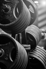 Weights in a workout gym. Gym interior close up, machinery and weightlifting equipment in modern urban style.