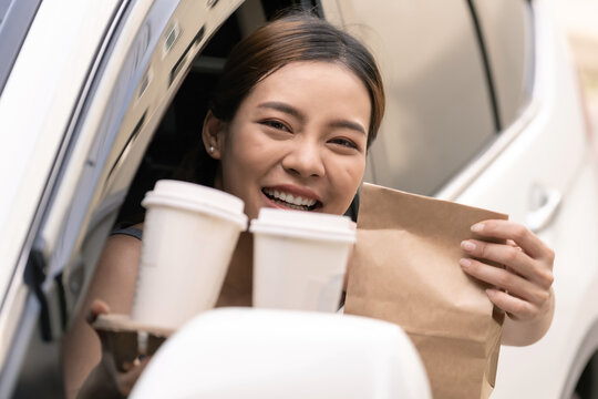 Asian Woman Holding Food Bag From Drive Thru Service Restaurant