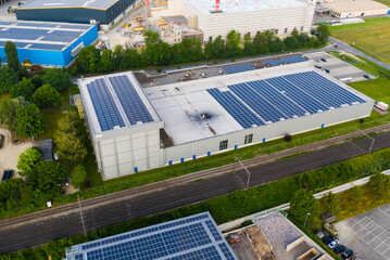 modern industrial building with solar cells on electric railway line