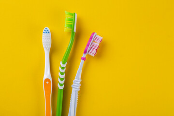 Toothbrush isolated in yellow background.