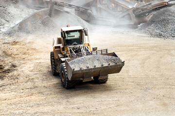 heavy duty excavator working at quarry moving gravel and rocks