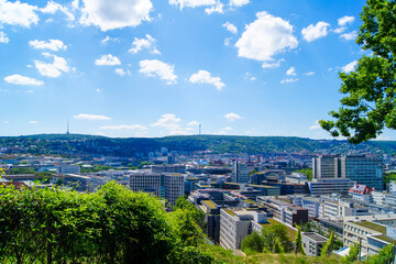 Spectacular view of the city of Stuttgart, Germany. A great city panorama under a bright summer sky. Green forests surround the city. - obrazy, fototapety, plakaty