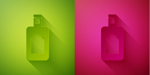 Paper cut Whiskey bottle icon isolated on green and pink background. Paper art style. Vector Illustration