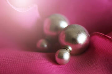 Setae earrings studs set on a pink fabric