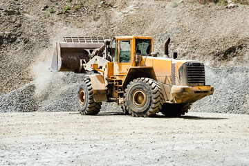 Wheel loader machinery bulldozer working on highway construction site