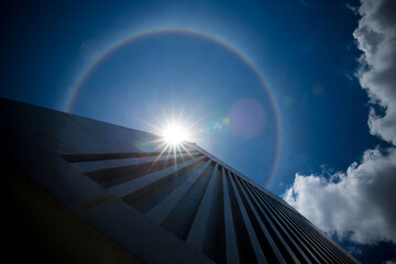 Amazing natural phenomena. Sun halo in Thailand or the sun with a rainbow on a tall building.