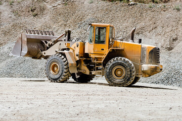 Wheel loader machinery bulldozer working on highway construction site