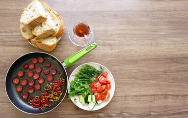 Banger (sujuk) breakfast, tomato, cucumber, dill, parsley, green pepper, red pepper, breads and tea