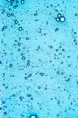Naklejka na ściany i meble Liquid blue cosmetic gel on a digital screen of microscope or sparking water