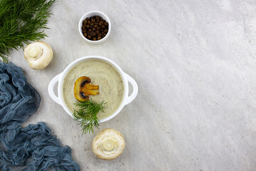 Fototapeta na wymiar Mushroom cream soup in white bowl on light background.