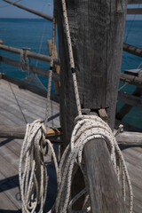 Close up of the rotating vertical wooden axis, beams and ropes of a traditional fishing trabucco to lift the net up at the beach near Vieste , Italy