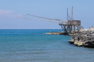 Typical traditional fishing trabucco at the beach of Vieste along the Adriatic Sea in Puglia, Italy, Europe. 
