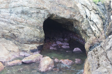 sea cave and rocks on coastline of beach