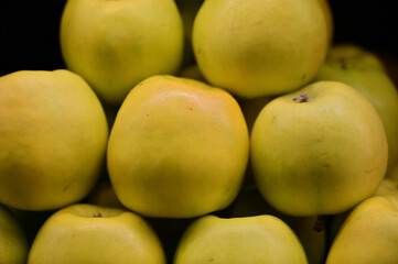 A large photo of fruit apples on a tray in a store, ready to sell fruit