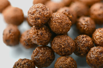 Breakfast cereal balls with chocolate on a white background