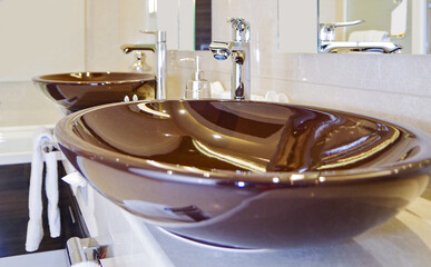 Elegant and modern design bathroom with double vanity and brown porcelain sinks  in clean style in...