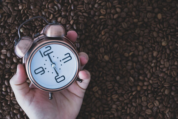 morning time coffee time. alarm clock on coffee beans. waking up and drinking coffee. listening...